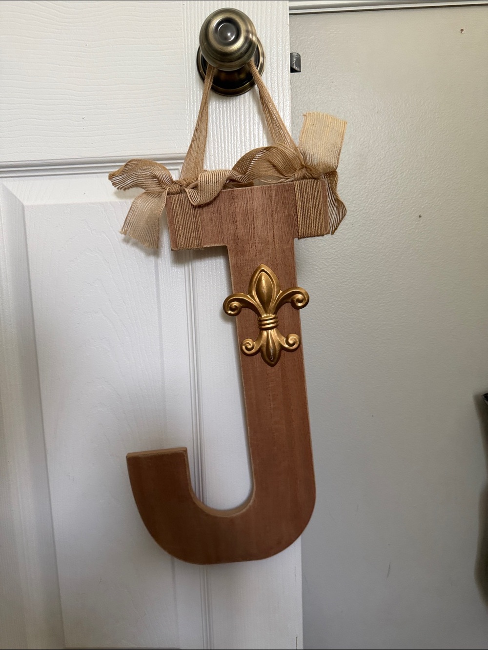 Kirklands Gold Fleur-de-Lis Wooden J Wall Accent in Tan